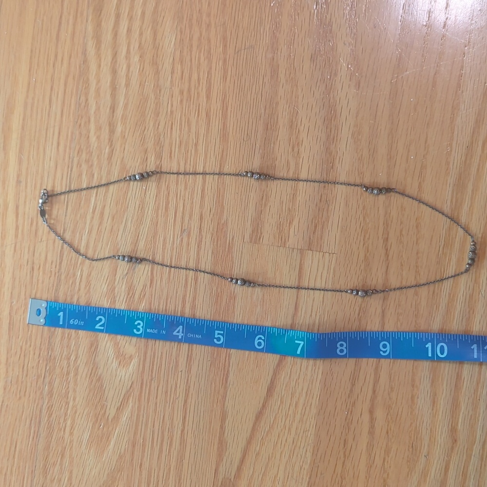 Necklace with groups of small metal beads